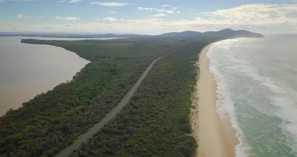 Spectacular aerial flight over a coastal road and wild colorful ocean, Australia