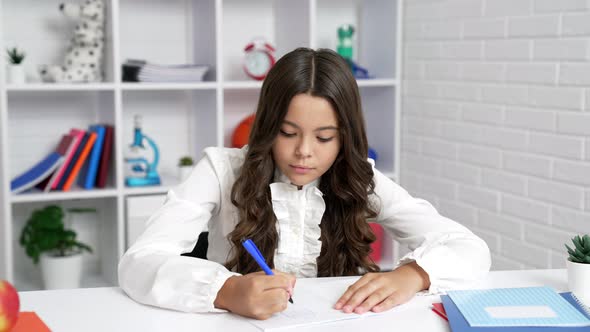 Pondering Child in School Uniform Writing Homework School