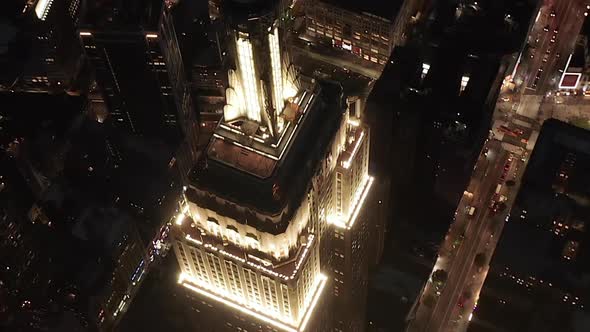 AERIAL: Breathtaking Circle Over the Iconic Empire State Building Above Lit Up Parallel Avenues and