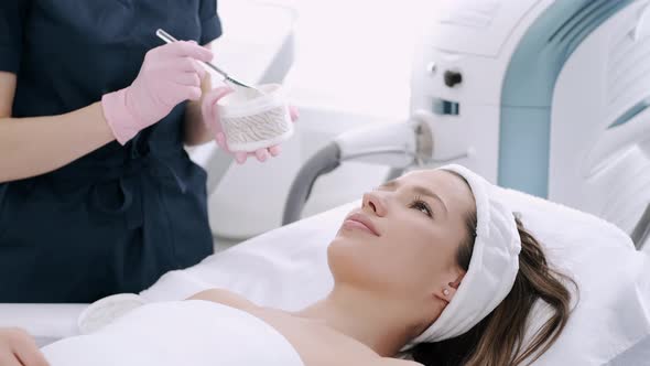 Cropped View of Beautician Putting Facial Mask on Face