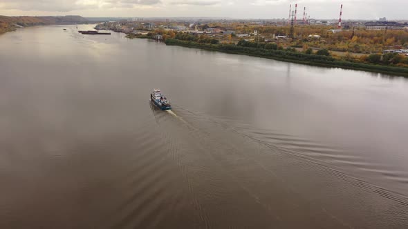 Motor Boat Tug Goes Along the River in Autumn