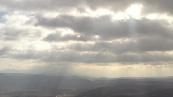 Clouds and sun rays above the valley 4K drone video