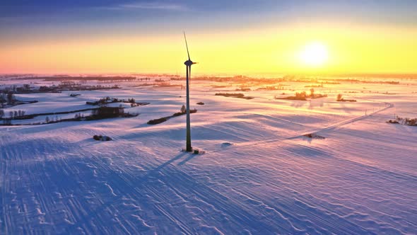 Alternative energy. Winter field and wind turbine.