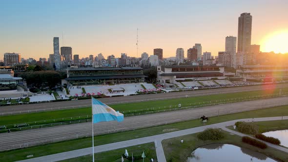 Aerial pan shot overlooking at Hipodromo Argentino de Palermo horse racing course with Argentina fla