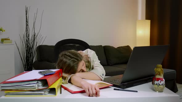 Tired stressed overworked business woman falling asleep at desk