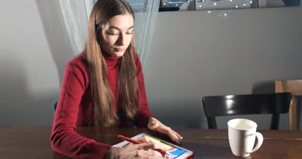 Talented Innovative Pretty Female Designer Sitting and Working at Desk. Contemporary Young Woman