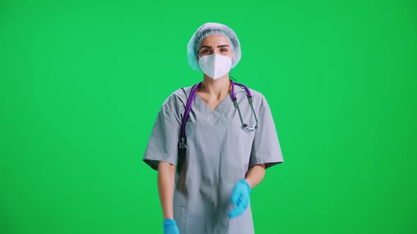 Portrait of Young Female Doctor in Protective Gear and Medical Mask Woman Looks at the Camera and