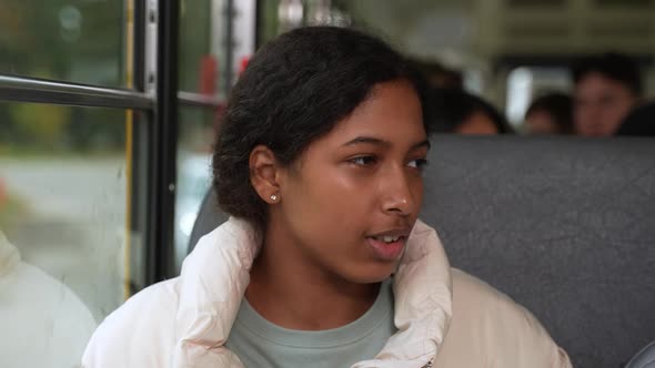 Cute Indian Girl Talking to Classmate on Schoolbus