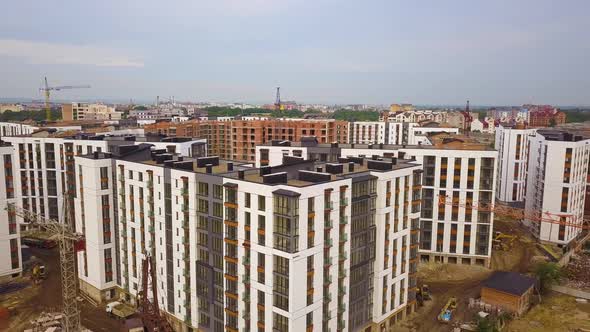 Aerial view of city residential area with high apartment buildings under construction.