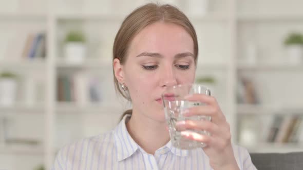 Portrait of Beautiful Young Woman Drinking Water