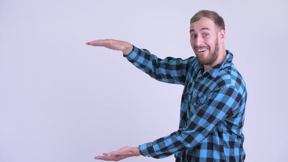 Happy Bearded Hipster Man Snapping Fingers and Looking Surprised