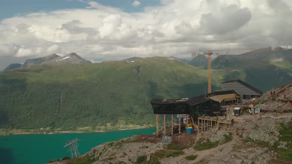 Tourists At Eggen Restaurant Overlooking Green Mountains And Fjord In Andalsnes, Norway. - aerial or