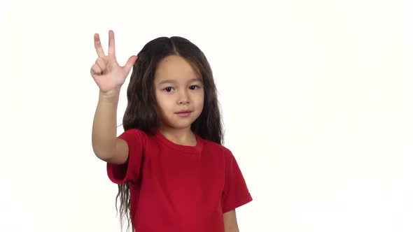 Child Counting Fingers Her Hands on White Background. Slow Motion