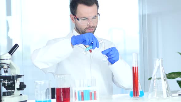 Scientist Busy Doing Research and Reaction in Laboratory