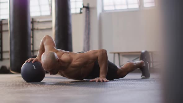 Fit caucasian man working out with medicine ball at the gym