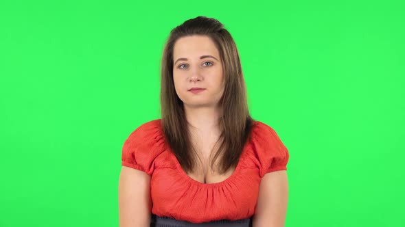 Portrait of Cute Girl Worrying in Expectation Then Smiles and Sighs with Relief. Green Screen