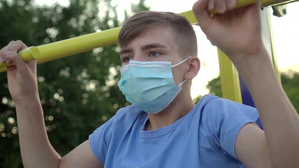 A Teenage Boy in a Medical Mask Is Engaged in Sports