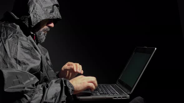 Computer Hacker Stealing Data From A Laptop