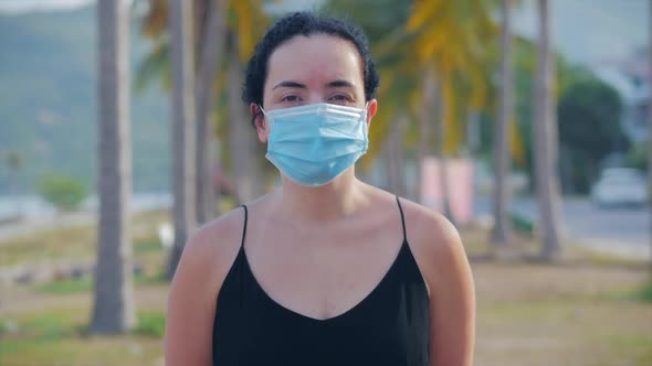 Portrait of Young Woman in a Mask From a Coronavirus Epidemic Wears Protective Demand in the Street