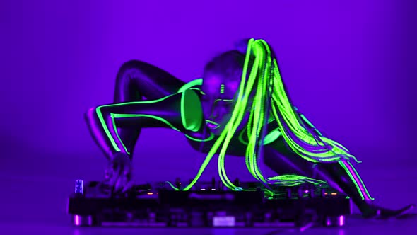 Wide Shot Cyborg Woman Dancing on DJ Set in Ultraviolet Light Looking at Camera