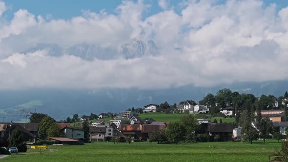 Panoramic View Liechtenstein with Houses on Green Fields in Alps Mountain Valley