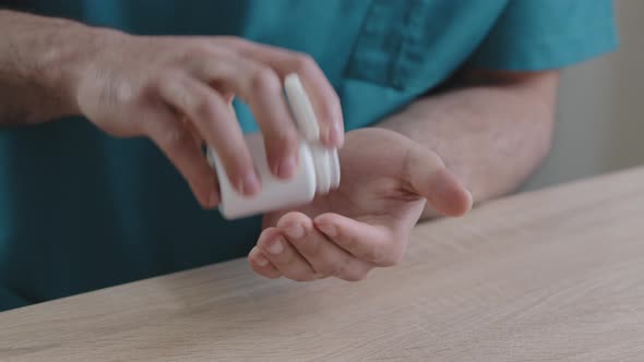 Close Up Body Part of Unknown Man Doctor Patient Putting Painkiller Pills in Male Hand From Meds