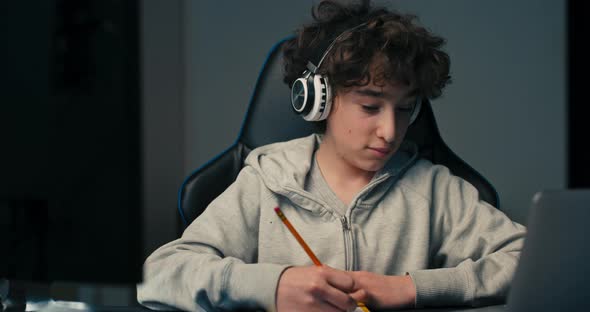 Face Portrait of a Boy with Curly Long Hair Wearing a Sweatshirt