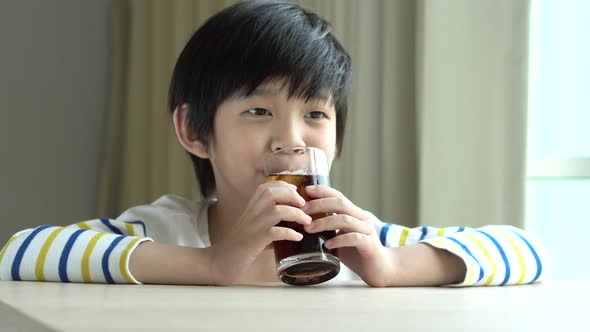 Little Asian Boy Drinking Soft Drink Cola Soda