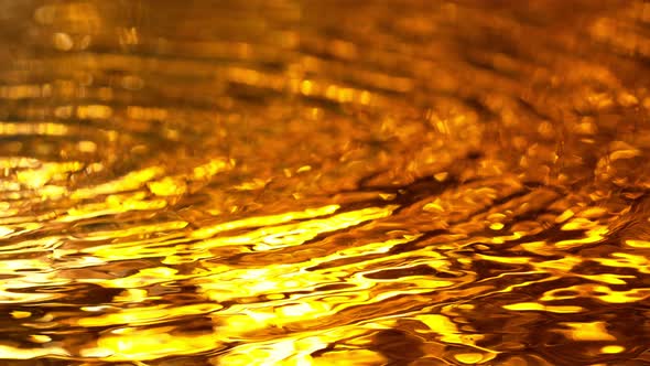 Super Slow Motion Shot of Waving Golden Liquid Texture at 1000Fps