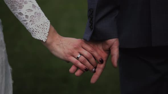 Wedding couple holding hands in slow motion