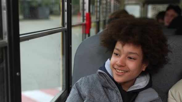 Cheerful Mixed Race Schoolboy Riding School Bus