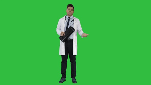 Doctor telling X rays results to camera on a Green Screen