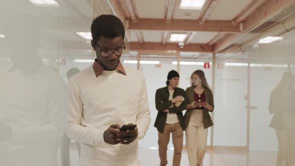 African-American Man Using Phone in Modern Office