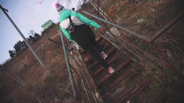 Young Beautiful Female Walking on the Stairs Leading to the Beach at Sunset