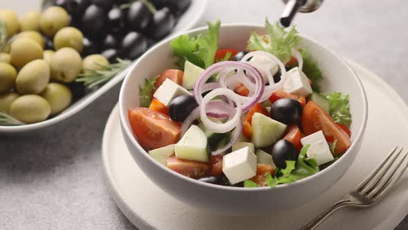 Greek salad drizzled with olive oil	