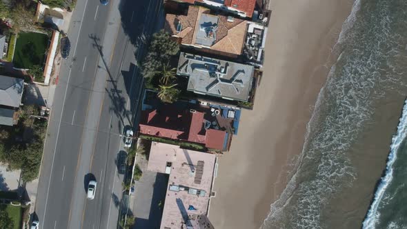 Afternoon camera down drone view and moving slowly down towards one of the population buildings of M