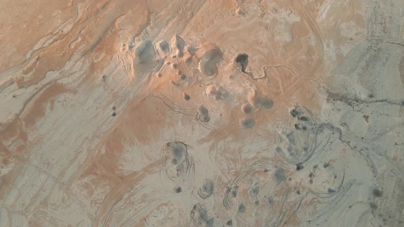 aerial drone above the desert with holes in the grounds at Judaean Desert