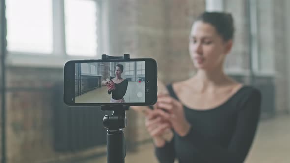 Female Ballet Teacher Recording Video On Smartphone