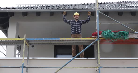 Smiling construction worker on scaffold