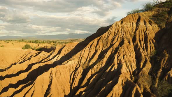 Aerial flies over the Tatacoa Desert during Golden Hour, revealing the Landscape.