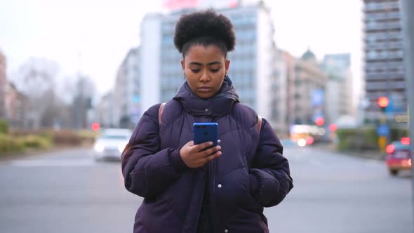 Time lapse young black woman outdoor using smart phone