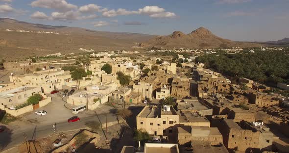 A Village Surrounded By Walls, Made of Soil. alt