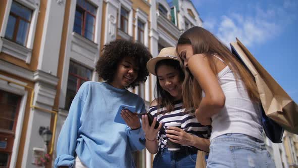 Multiracial Girls Sharing Smart Phone Outdoors