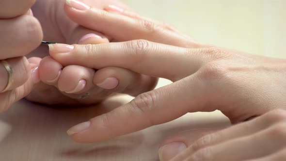 Manicurist Applying Colorless Varnish.