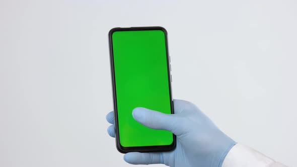 Hand in Medical Glove Using Smartphone with Green Screen