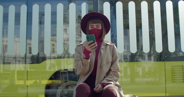 Crop View of Stylish Woman Using Smartphone While Sitting at Public Transport Stop, Girl in Cotton