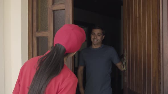 Delivery Girl Knocking at Door and Giving Packet To Customer