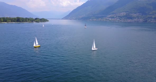 Aerial drone view of sailboats sailing on Lake Maggiore, Switzerland.