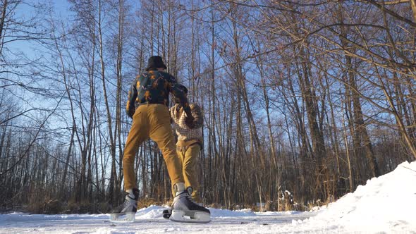 Two Indian and European Boys Learn To Skate on a Frozen Lake and Play Mischief