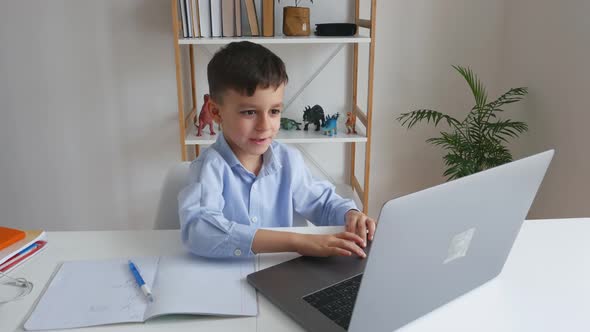 Kid Via Laptop Talking with Teacher During Online Studying at Home